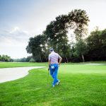 Beautiful golfing scenery with a golfer holding a club